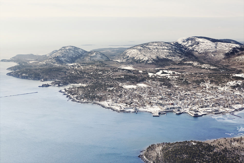 The edge of the earth: An aerial view of Mount Desert Island takes in the town of Bar Harbor, vast Frenchman Bay, and Acadia's wintry wilderness.