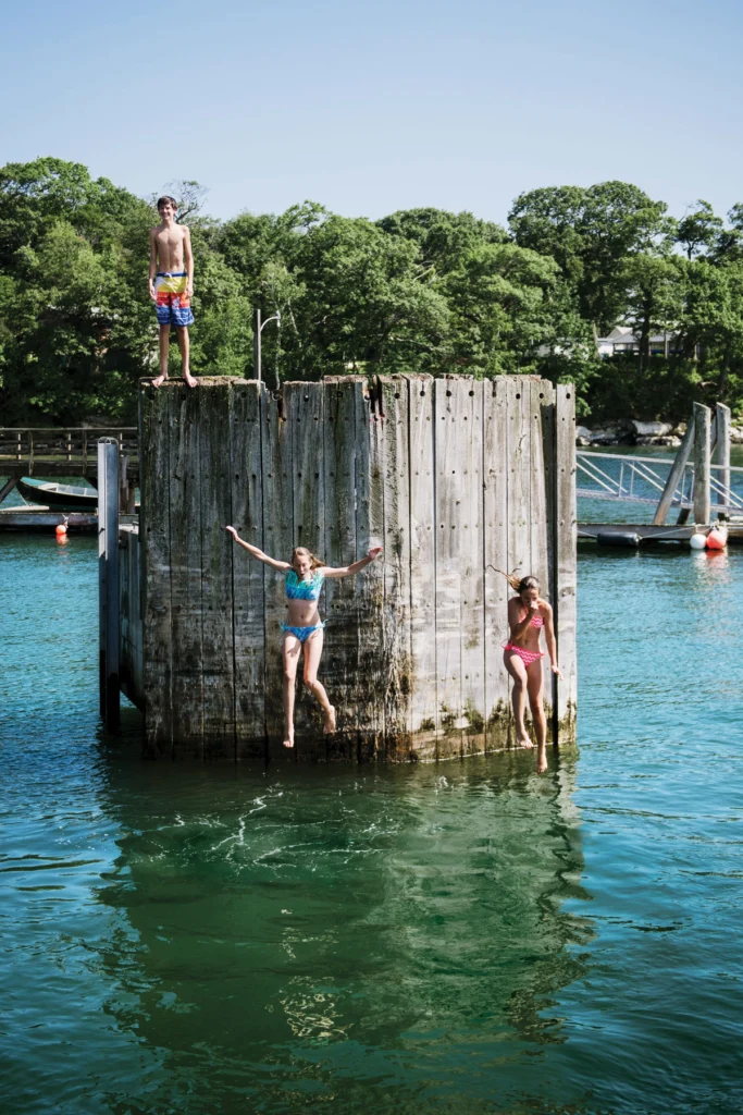 Children leap from the Peaks ferry terminal. 