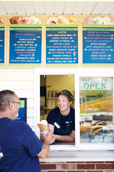Gifford's Ice Cream worker hands a cone to a customer