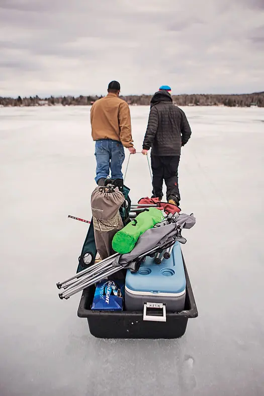 men use sled to transport things