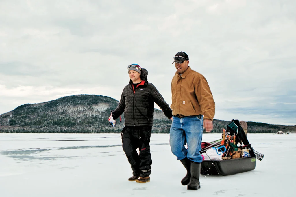 men use sled to transport things