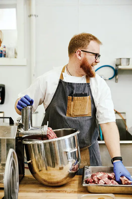 Man grinding meat