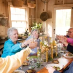 group of people toasting around a table