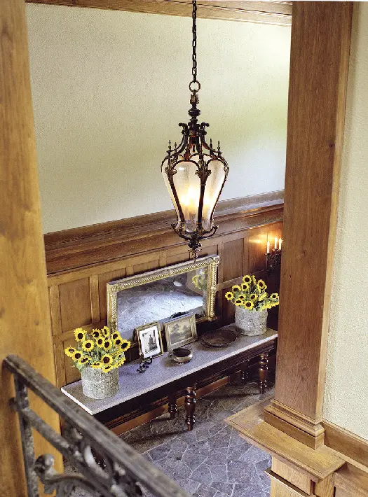 hallway with table with sunflowers on it