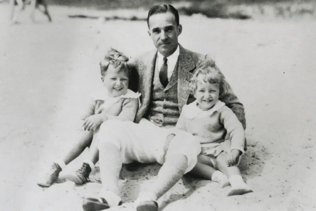 old black and white photo of chandler on the beach with this kids