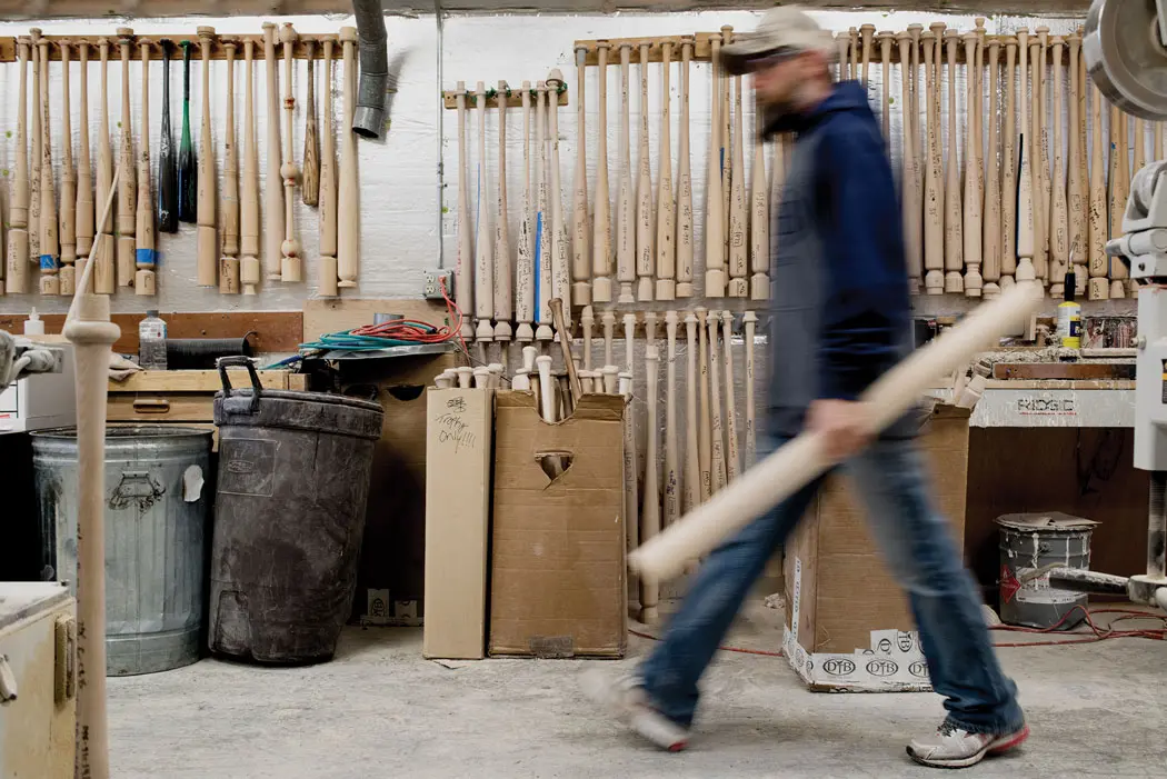 man carrying wood to be carved