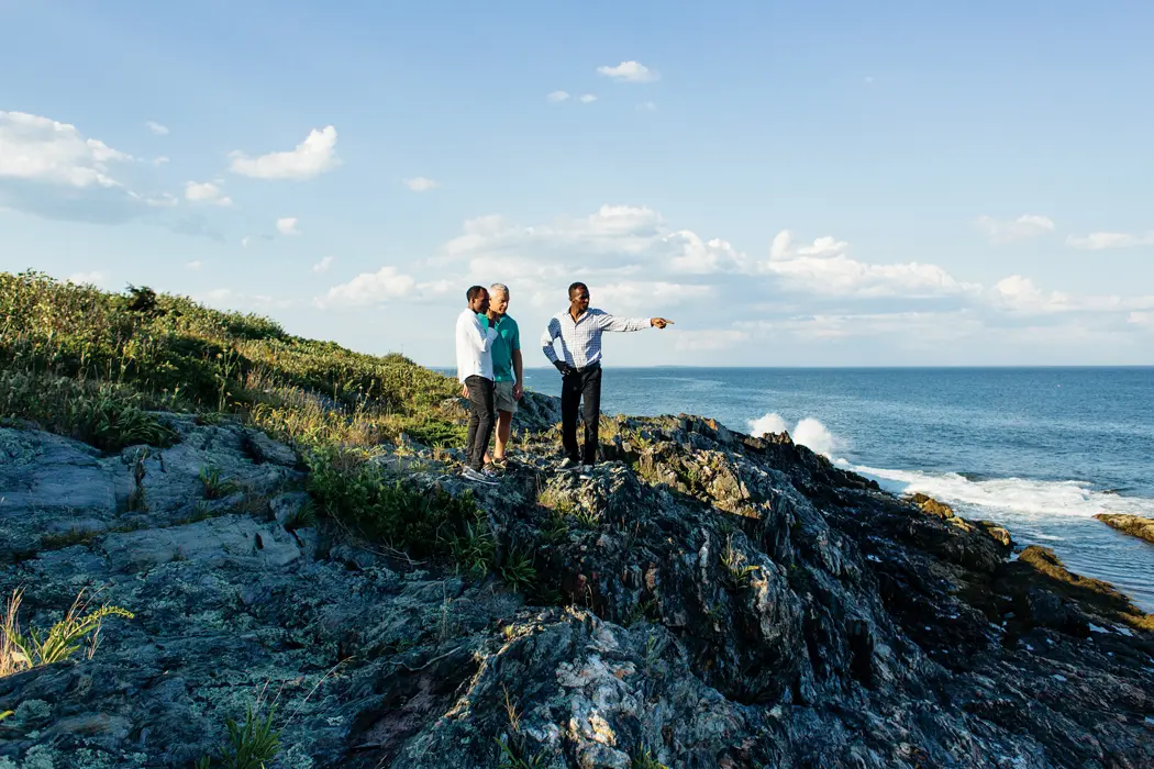 Mark Cook, center, of Cape Elizabeth, gives Tariku Bekele, left, and Markos Geneti, right, a tour around his Cape Elizabeth neighorhood.