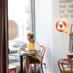 Woman reading newspaper at Biscuits & Company