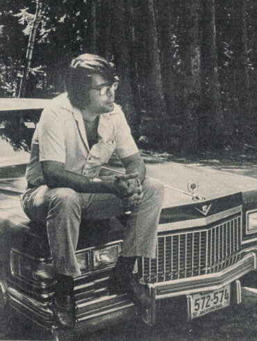 Stephen King, pictured on the hood of his Cadillac.
