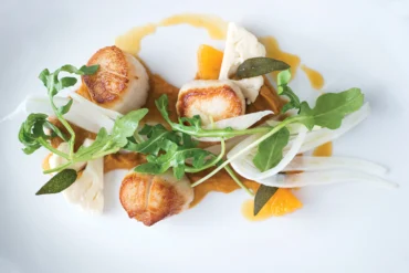 Musette - Maine scallops with butternut puree, orange reduction, fennel, arugula, and crispy sage.