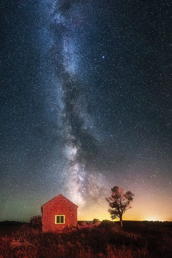 Milky Way over red shed in field