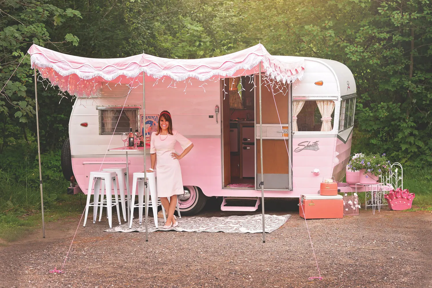 Stephanie Towle standing in front of her pink refurbished 1964 Shasta 16SC