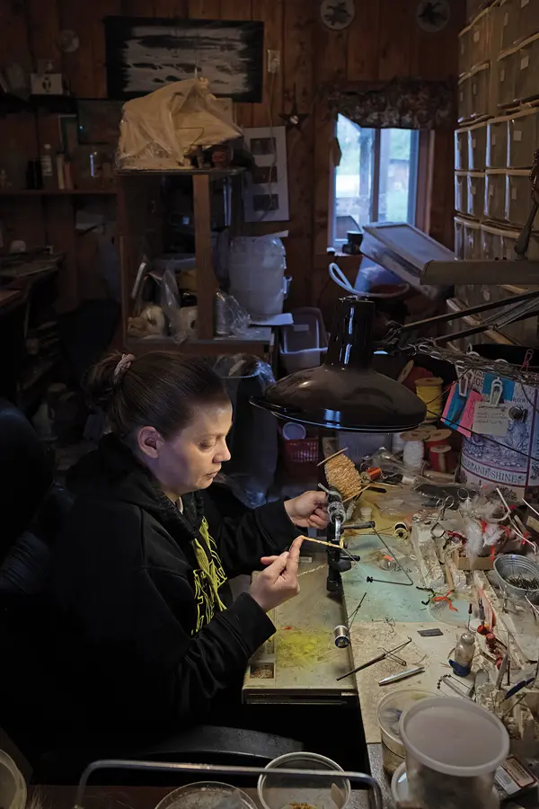 Amanda Desrosier ties all of the flies offered in Theriault’s shop.