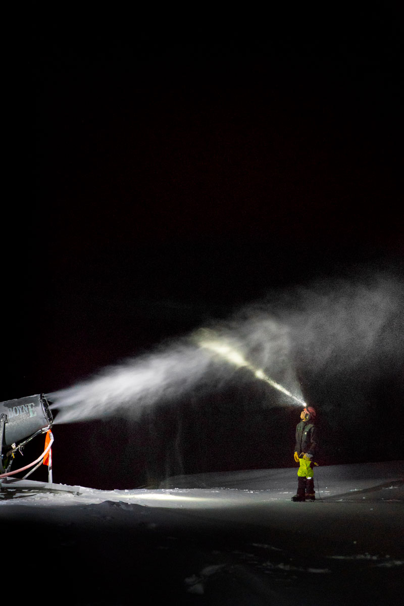 a snow gun with a technician standing in front of it