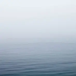 By the water