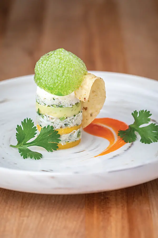 Cilantro foam on a crab, avocado, and mango tower uses Foam Magic powder.