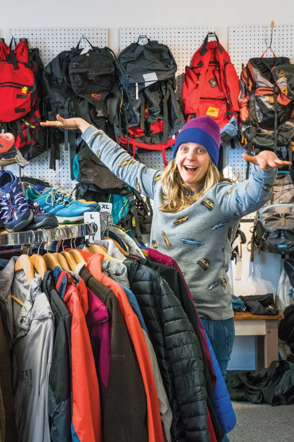 Trying on gently used outdoor gear at Woods + Waters Gear Exchange.
