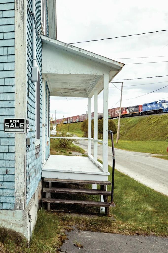 A Canadian National Railway train passes atop the berm in front of Scot Bubier’s camp, the northernmost house east of the Mississippi.