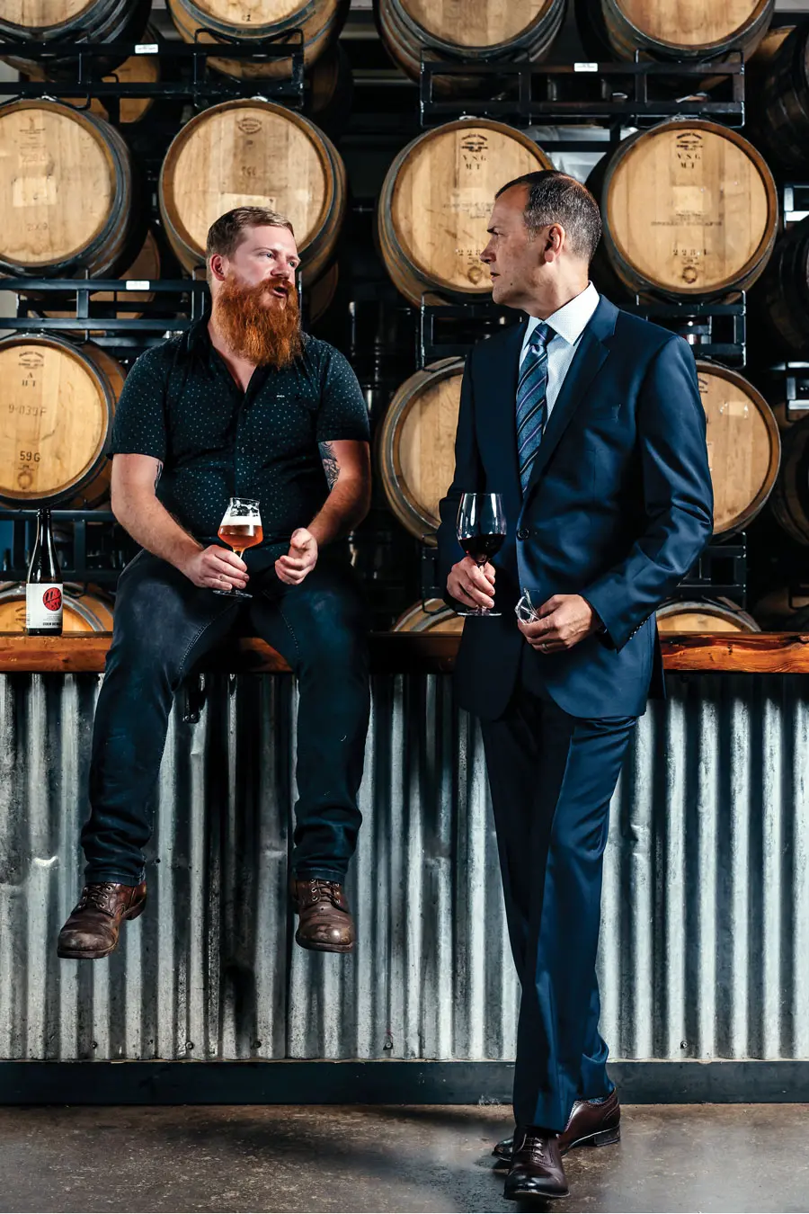 Beer aficionado Jack van Paepeghem (left) and wine pro Scott Tyree talk shop in Oxbow’s Portland barrel room.