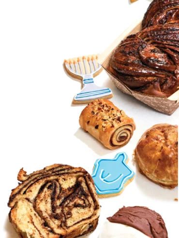 Hanukkah cookies, and, from top to bottom, chocolate babka, Nutella-rolled rugelach, potato knish, sliced babka, and black-and-white cookie from Tin Pan Bakery in Portland Maine