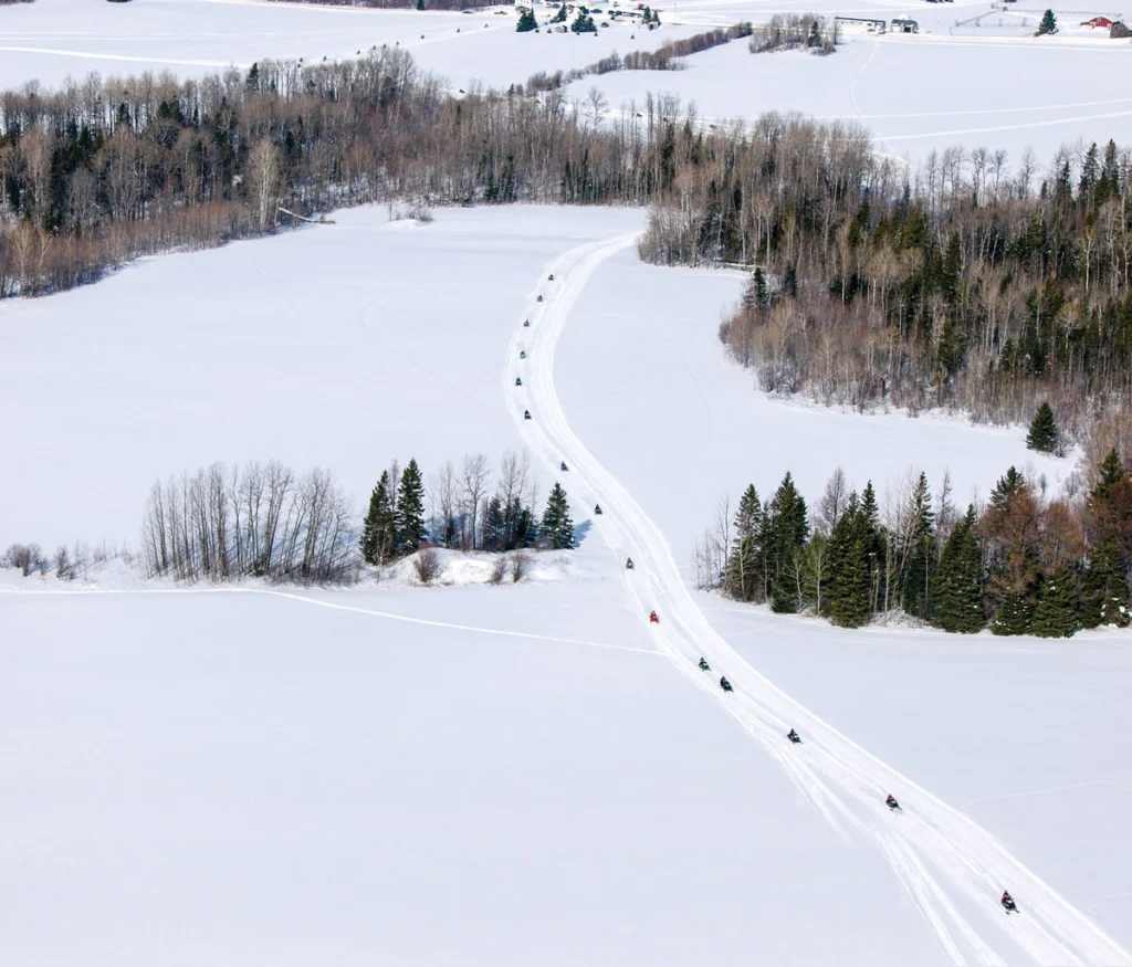a group snowmobiling Aroostook County
