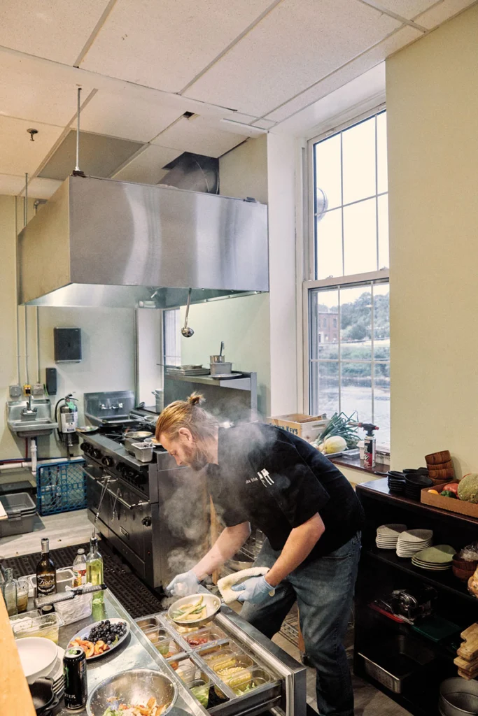 At Oak Table and Bar, chef Elisha Irland prepares a meal