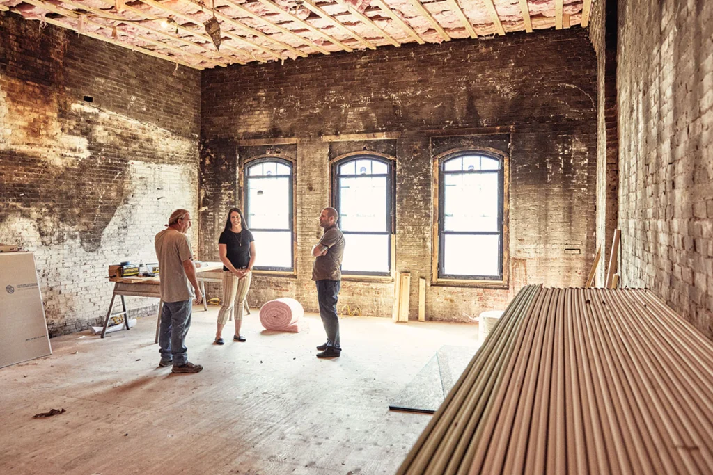 Peter Bolduc, left, chats with Heather Pouliot, chair of the Augusta Downtown Alliance, and developer Tobias Parkhurst