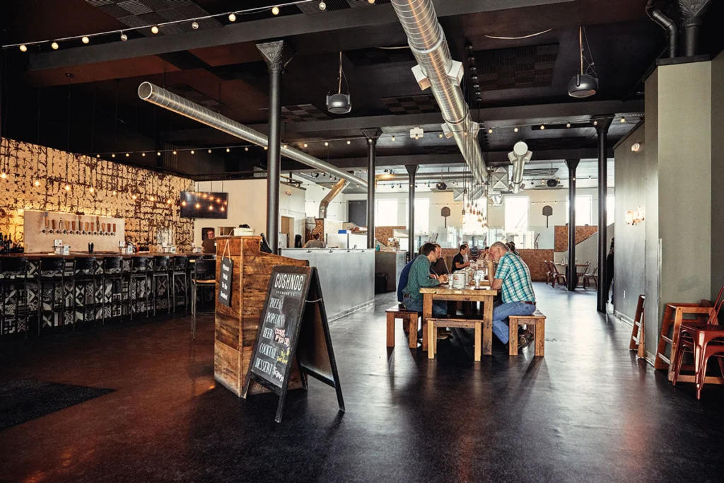 Diners enjoying pizza and beer at Cushnoc Brewing Company