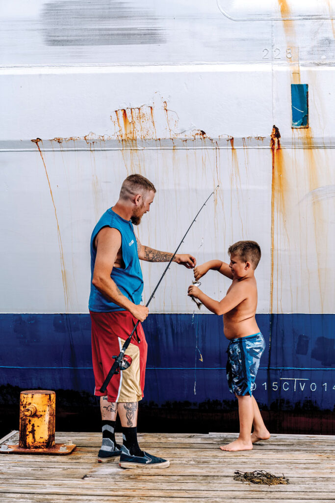 Zachary Rhoades and his son, Corbyn, fishing at the pier, a rite of summer in Eastport.