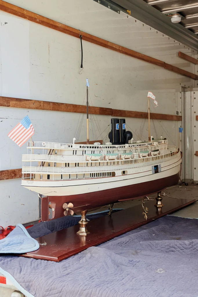 Gargantuan model ships, seen here headed for the auction block, were among the assets from Northport’s once extravagant Point Lookout. Photographed by Tristan Spinski