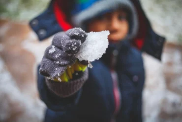 kid playing with snow