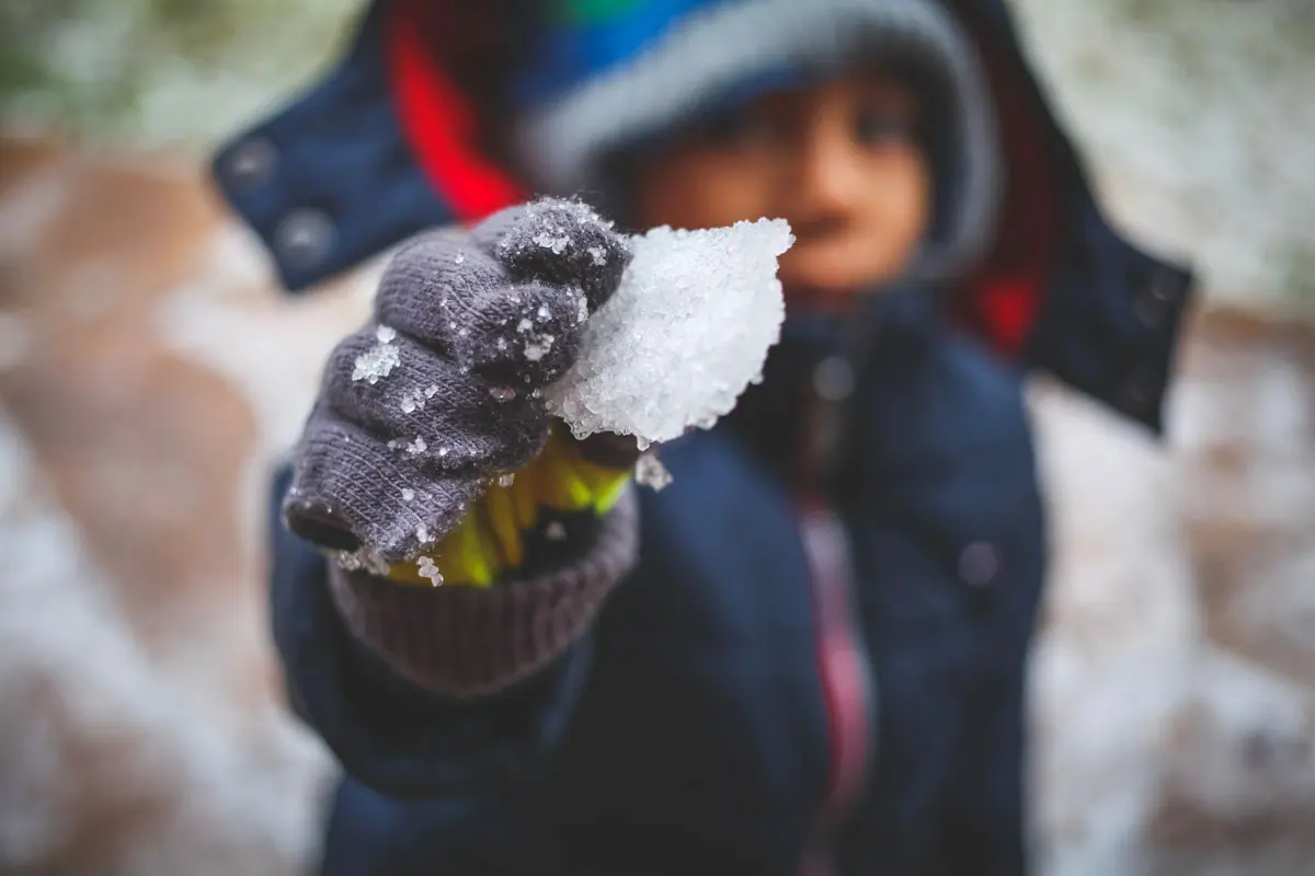 kid playing with snow