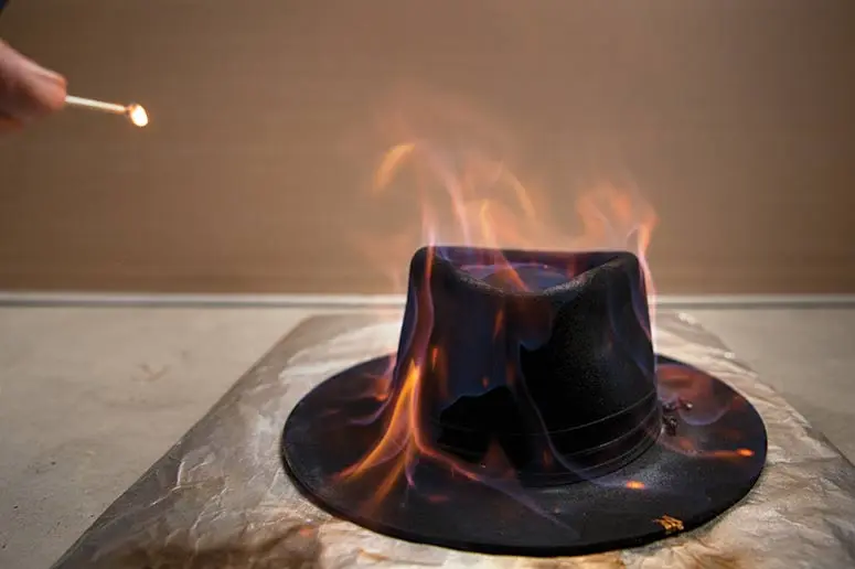 Meg Patti uses fire to distress the material to lend a hat some character.