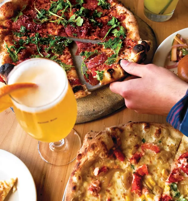Bruno's spicy soppressata pie and a Maine lobster pizza with caramelized onions, roasted corn, and green onions 