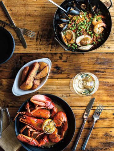 From Wiscasset's Water Street Kitchen & Bar: paella with Maine mussels and littlenecks; roasted lobster with whiskey- tarragon butter; truffle fries