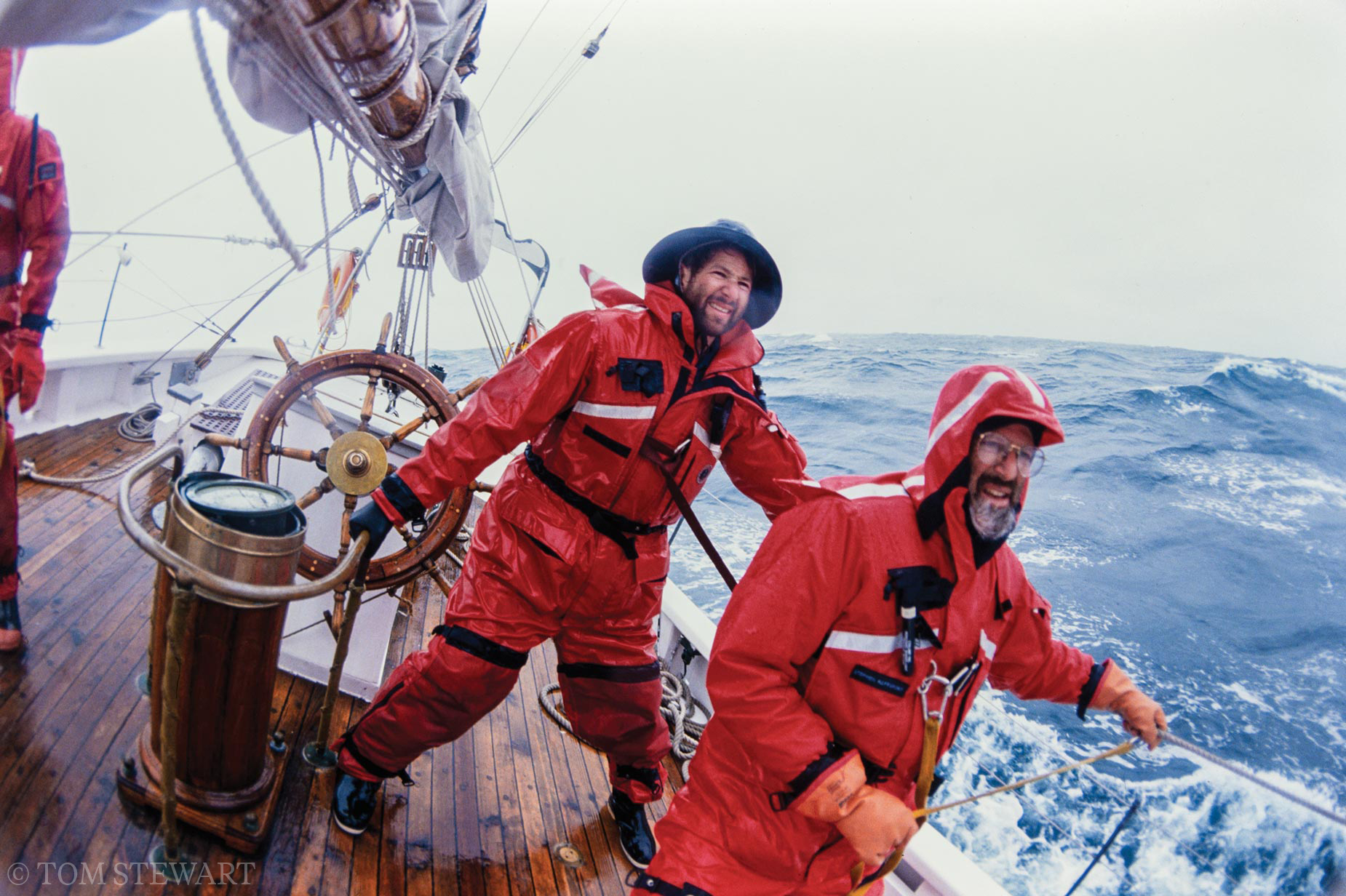 Captain Elliot Rappaport holds onto the rail of the schooner Bowdoin