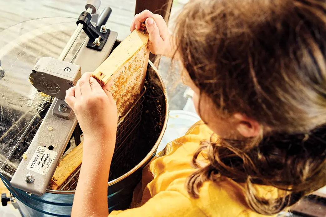 The only beekeeping work Elizabeth Downs has her mom do is lighting a handheld smoker