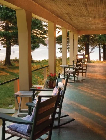 Roger Angell watches the sun set from the porch of his 101-year-old Brooklin, Maine, cottage