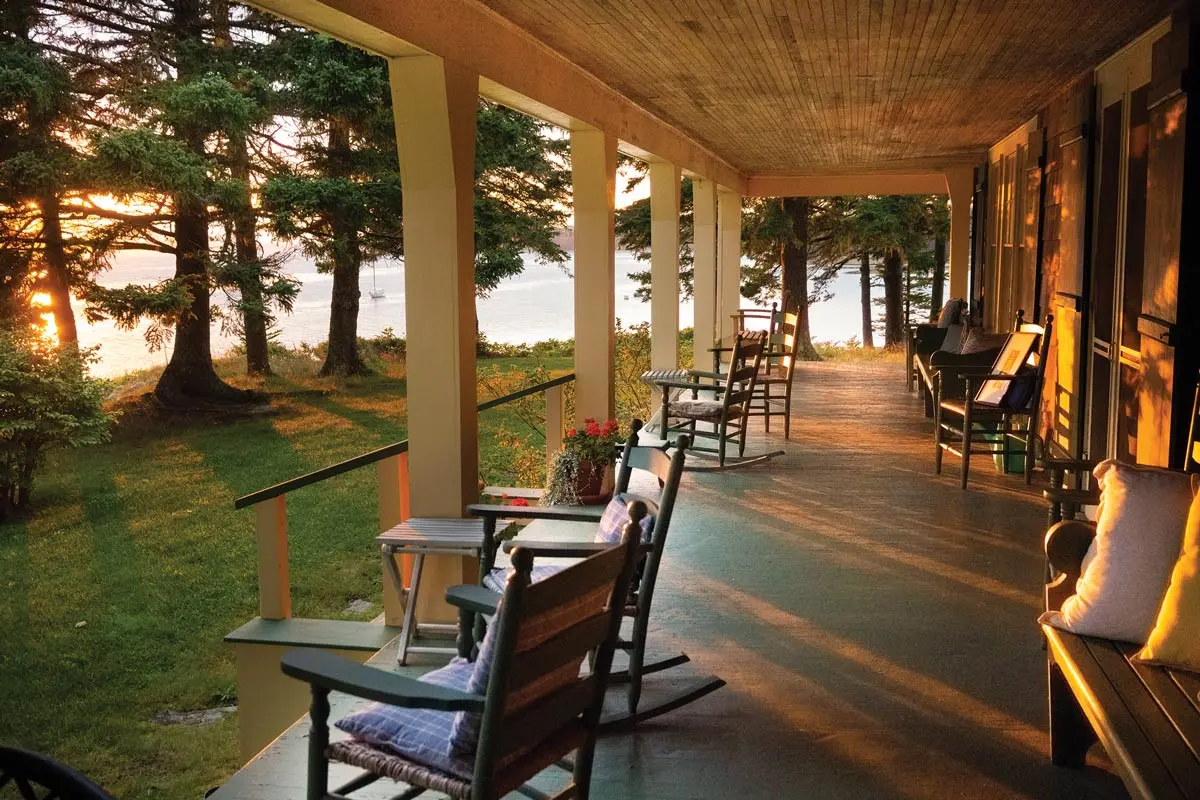 Roger Angell watches the sun set from the porch of his 101-year-old Brooklin, Maine, cottage
