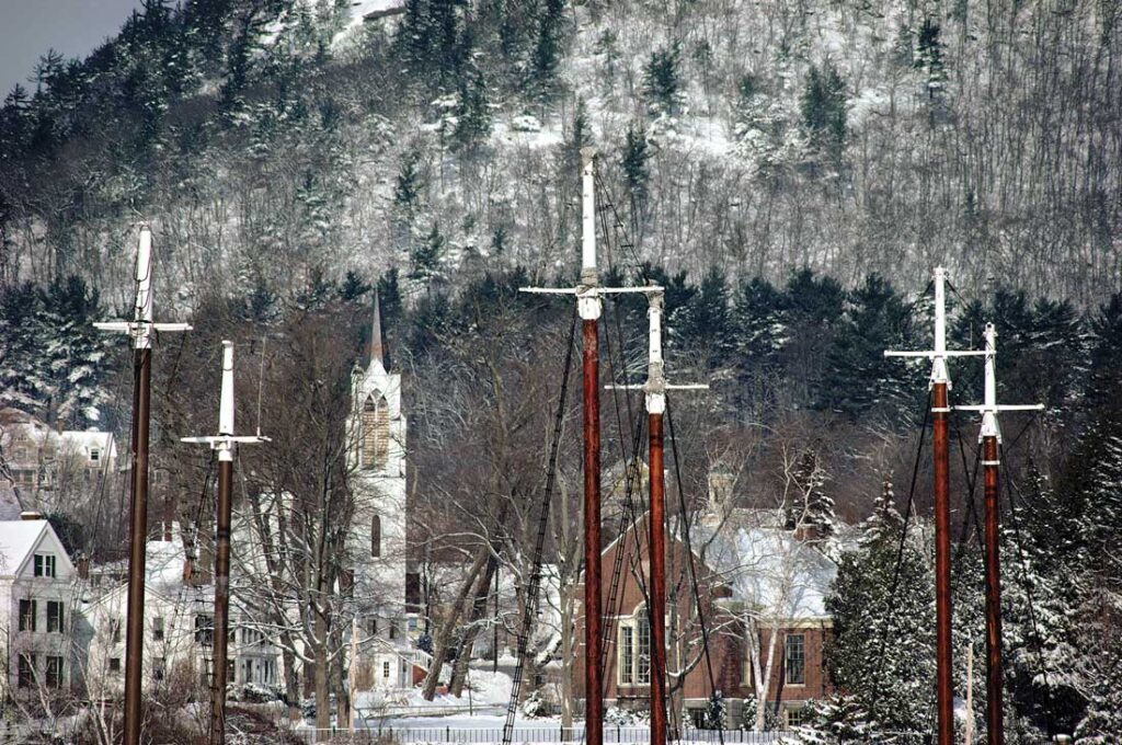 The steeple from Camden’s former Methodist church, built in 1893, rises up behind ship-mast crosses in the harbor in this photo that Ralston calls Faith, taken in 1989.