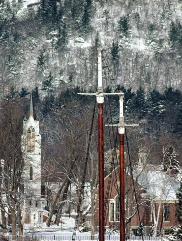 The steeple from Camden’s former Methodist church, built in 1893, rises up behind ship-mast crosses in the harbor in this photo that Ralston calls Faith, taken in 1989.