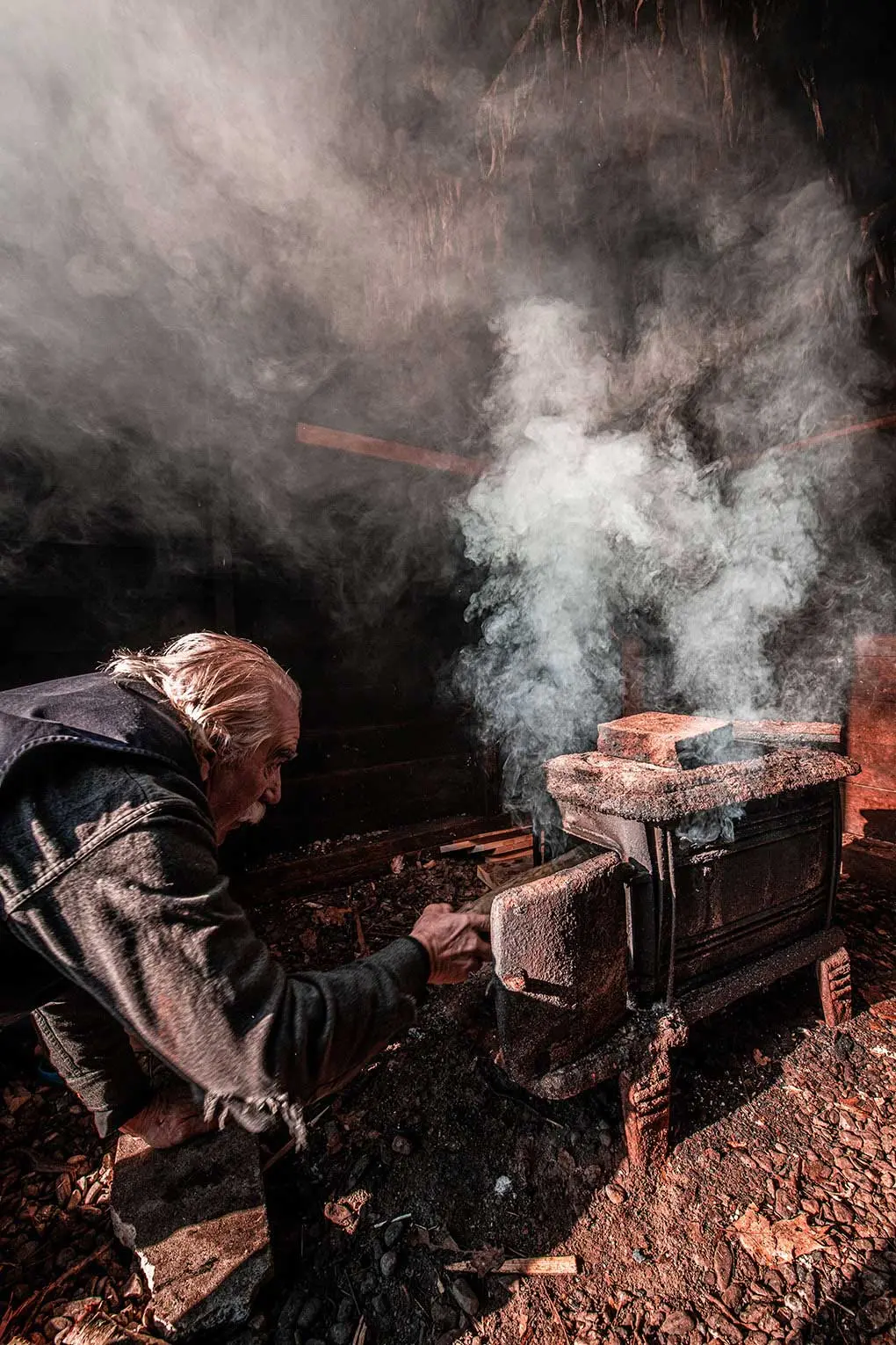 Brothers Ken and Todd Lincoln tend a slow-burning fire in South Bristol's herring smokehouse