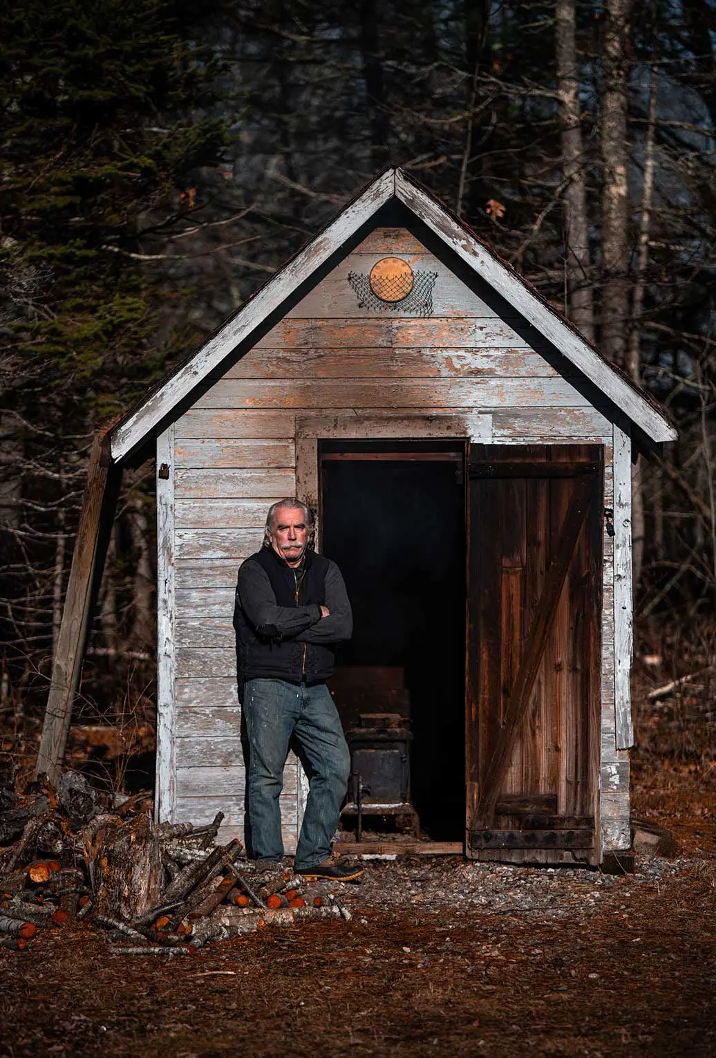 Brothers Ken and Todd Lincoln tend a slow-burning fire in South Bristol's herring smokehouse