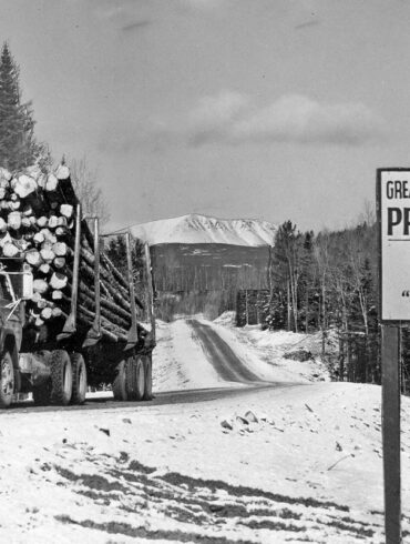 truck and sign on the golden road in Millinocket