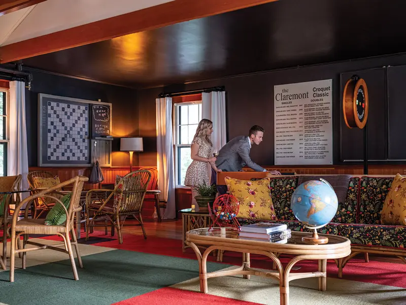 Aman and a woman standing in the Croquet Club at The Claremont hotel