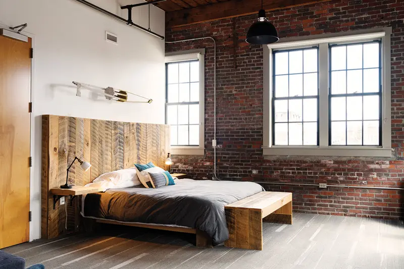 Mill Inn bedroom. The bed's headboard and bench uses reclaimed wood.
