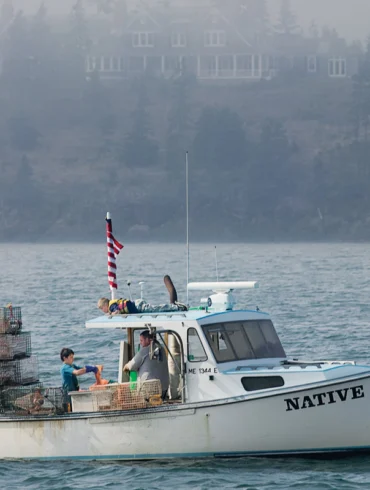 Ralston captured the Native Son hauling traps off North Haven in 2007, a grand summer home looming behind.