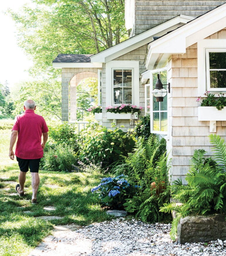 Cone flowers, ferns, hydrangeas, lavender, peonies, and yarrow encircle the cottage, which sports new cedar shingles, windows, and a reimagined porch.