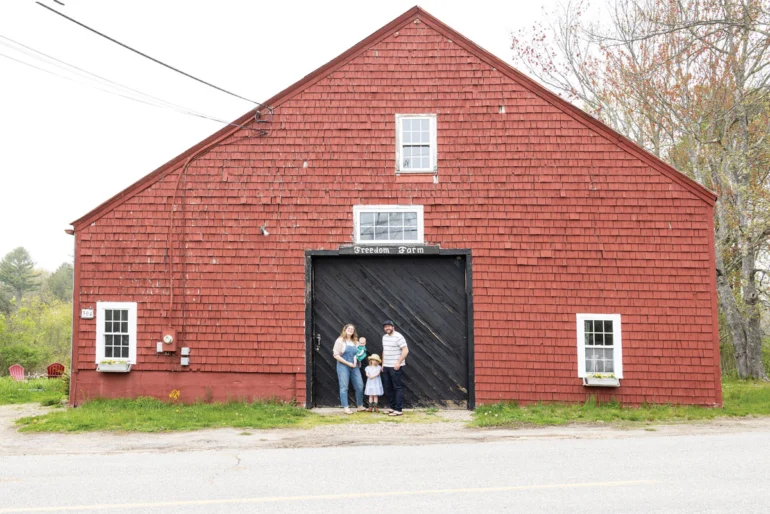 Bridget M. Burns, outside the Freedom Farm barn, with daughters Sinead and Clodagh and husband Kevin.