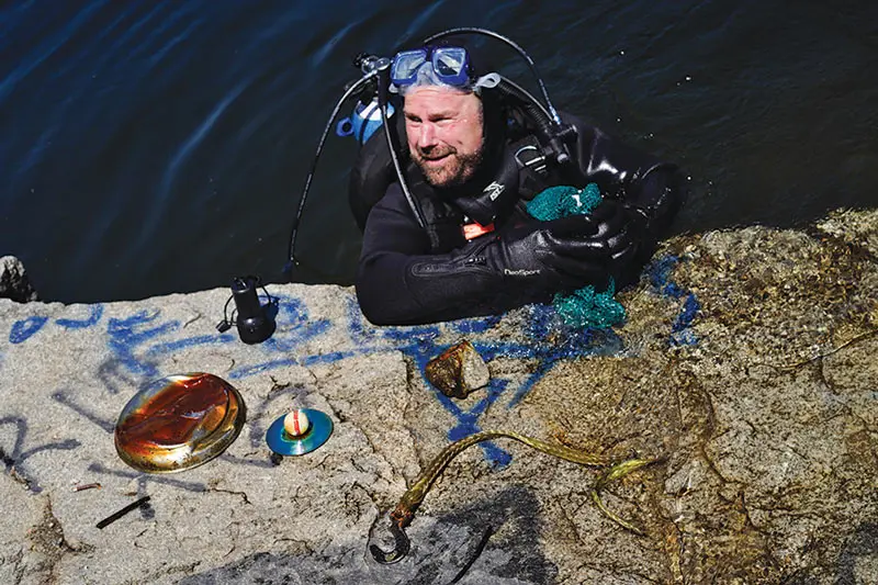 Diver Paul Dyer with some of his underwater finds.